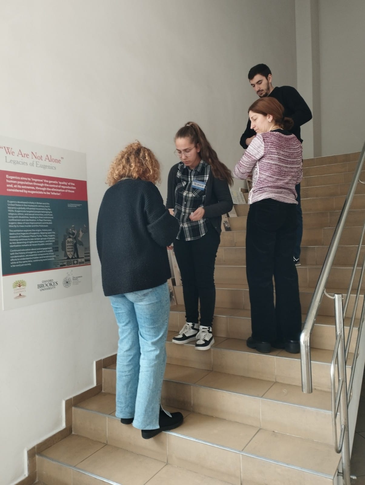 We Are Not Alone exhibition panel with students at Lucian Blaga University Library, Sibiu Transylvania